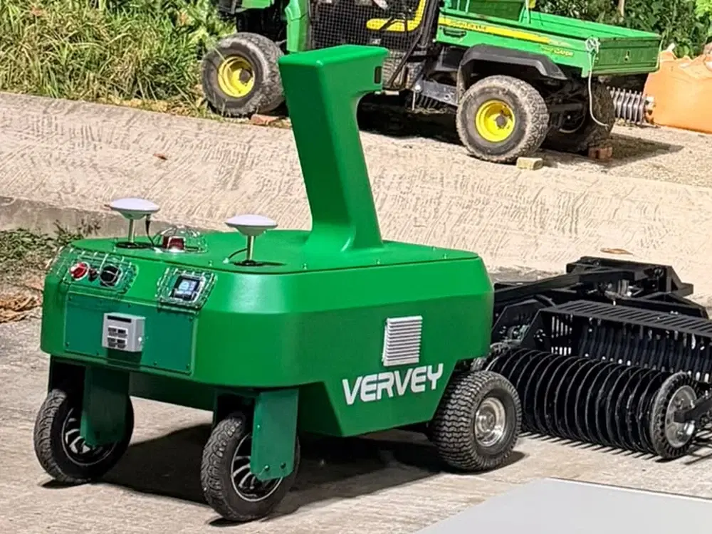 Green Vervey outdoor field robot with rake attachment